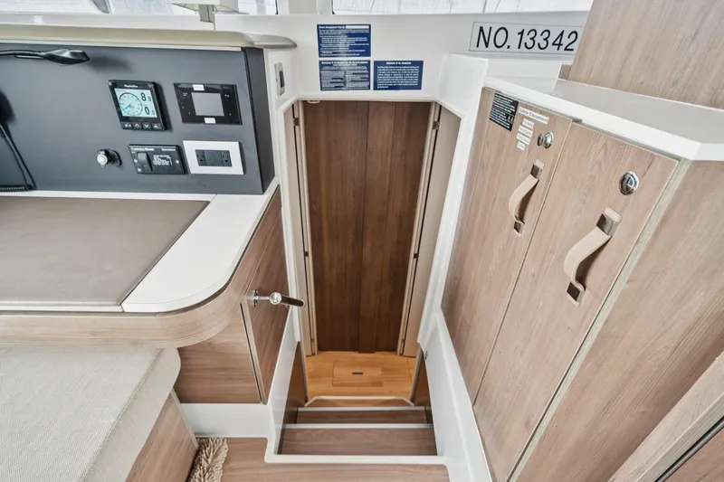 Cielo Yacht Photos Pics Interior of 2023 Bali 4.2 yacht, featuring control panel and wooden cabinetry.