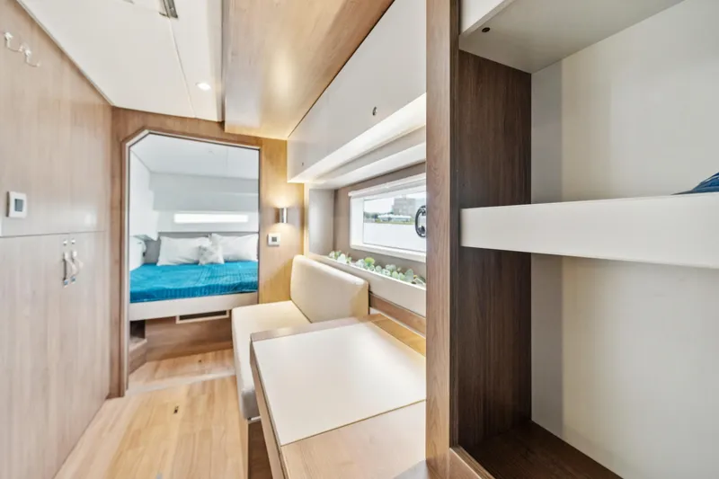 Cielo Yacht Photos Pics Modern interior of 2023 Bali 4.2 yacht with cozy seating and bedroom view.