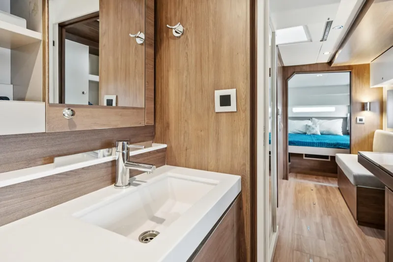 Cielo Yacht Photos Pics Modern interior of 2023 Bali 4.2 yacht featuring a sleek bathroom and cozy bedroom.