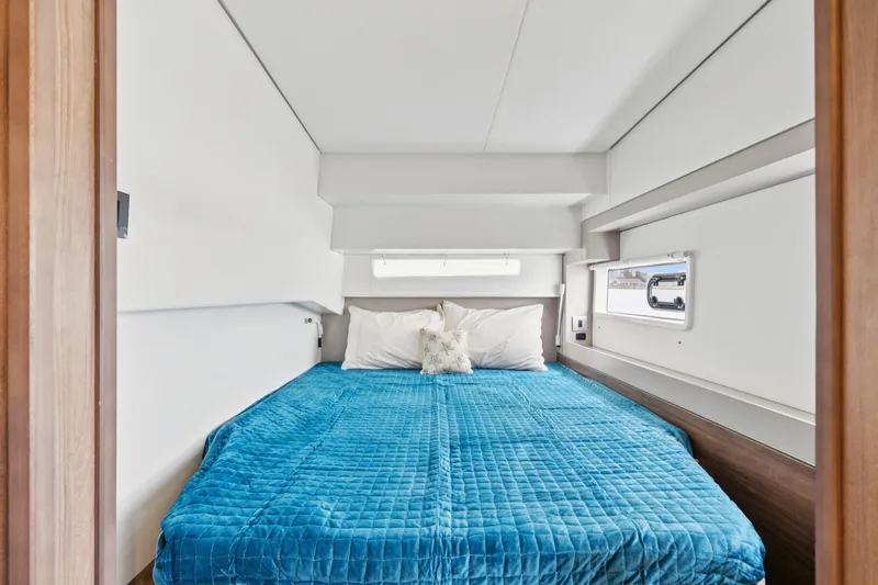 Cielo Yacht Photos Pics Luxurious cabin interior of 2023 Bali 4.2 yacht with blue bedding.