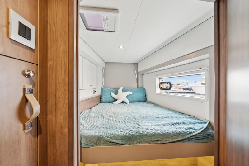Cielo Yacht Photos Pics Cozy bedroom in 2023 Bali 4.2 yacht with teal bedding and starfish pillow.