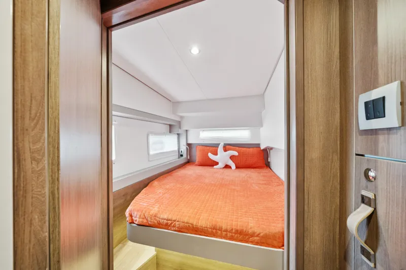 Cielo Yacht Photos Pics Cozy bedroom in 2023 Bali 4.2 yacht with orange bedding and starfish pillow.