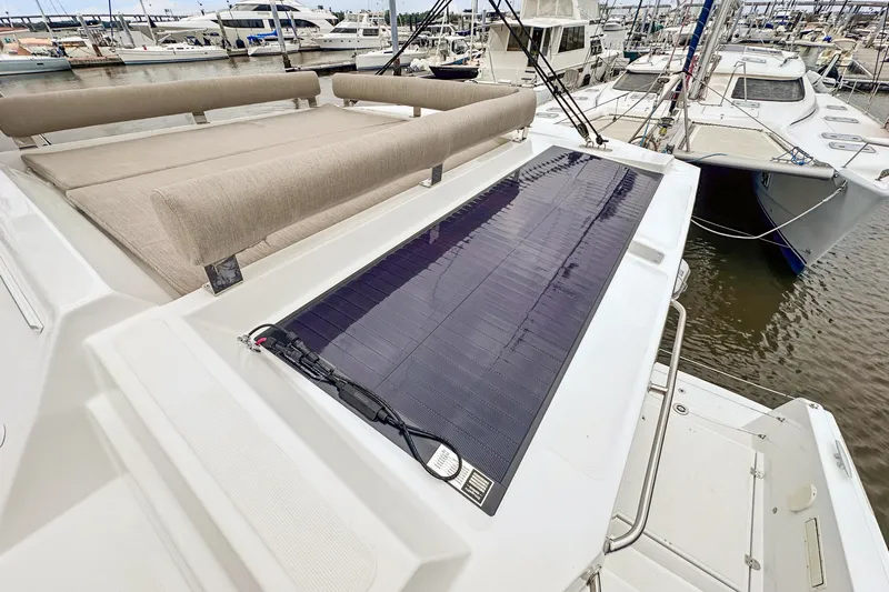 Cielo Yacht Photos Pics 2023 Bali 4.2 yacht with solar panel and cushioned seating at marina.