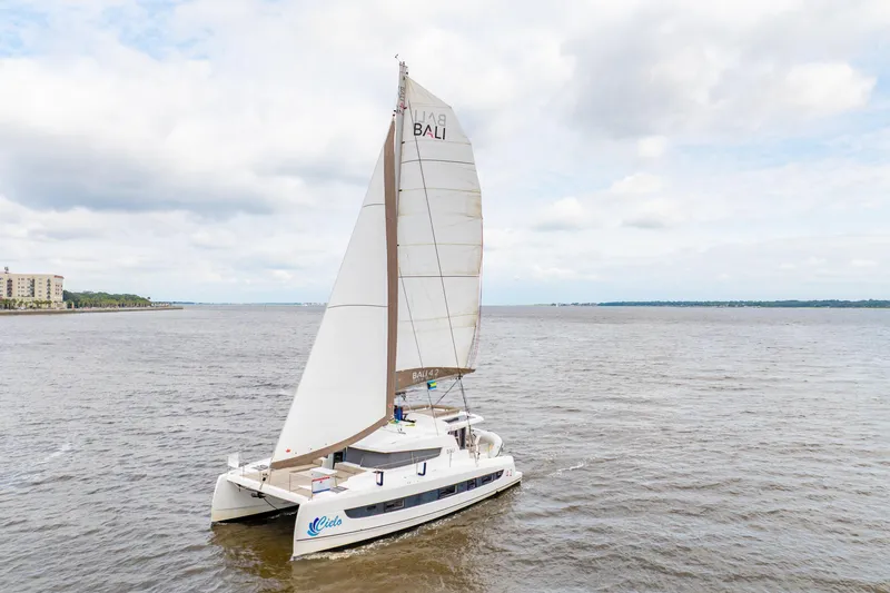 Cielo Yacht Photos Pics Sailing catamaran Bali 4.2, 2023 model, cruising on open water under cloudy skies.