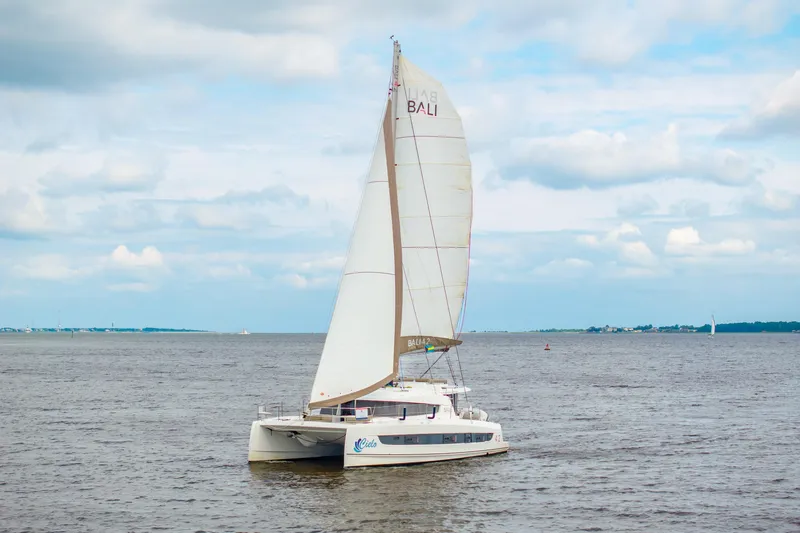 Cielo Yacht Photos Pics 2023 Bali 4.2 catamaran sailing on open water under a cloudy sky.