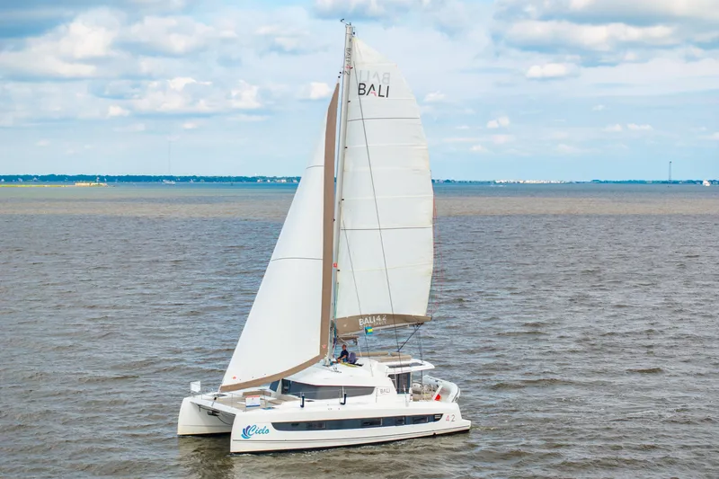 Cielo Yacht Photos Pics 2023 Bali 4.2 catamaran sailing on open water under a cloudy sky.