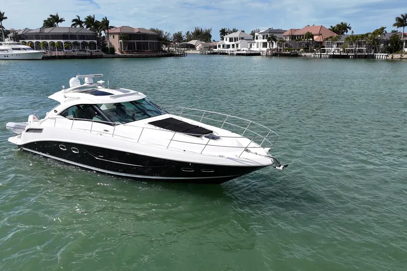  Yacht Photos Pics 2014 Sea Ray 470 Sundancer yacht cruising in a scenic waterfront area.