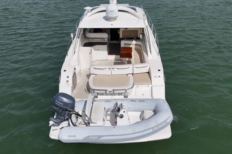 Yacht Photos Pics 2014 Sea Ray 470 Sundancer yacht with inflatable boat on water.