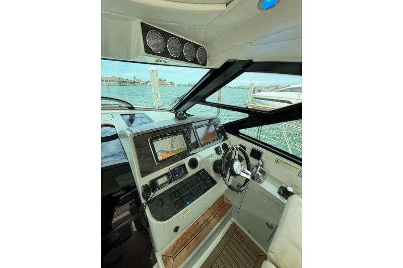  Yacht Photos Pics Helm of 2014 Sea Ray 470 Sundancer with modern navigation equipment and scenic marina view.