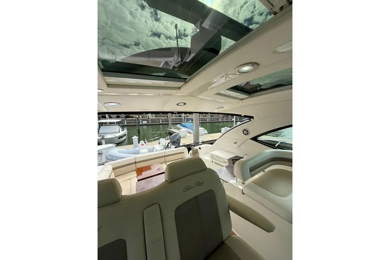  Yacht Photos Pics Interior view of 2014 Sea Ray 470 Sundancer yacht with open sunroof and luxurious seating.