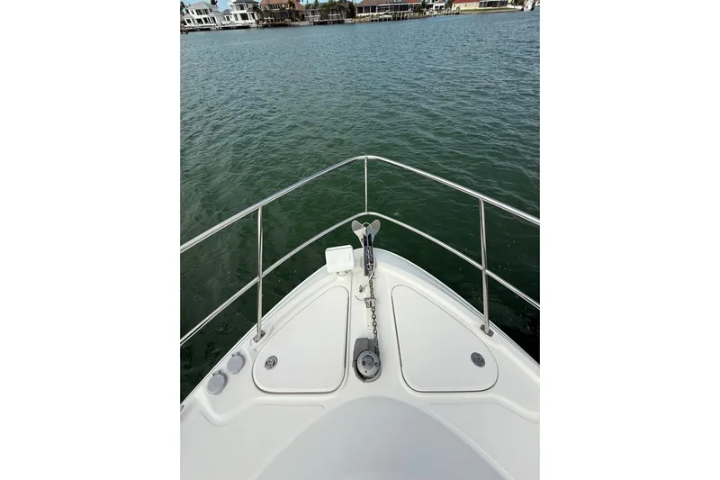  Yacht Photos Pics Bow view of 2014 Sea Ray 470 Sundancer yacht on calm water.