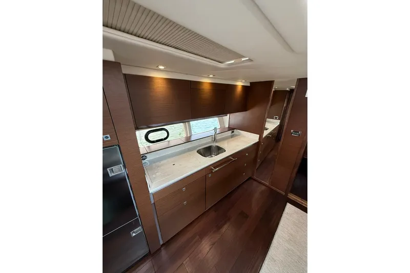  Yacht Photos Pics Luxurious interior of 2014 Sea Ray 470 Sundancer yacht with modern kitchen design.