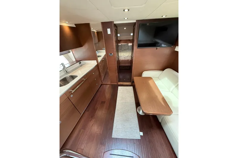  Yacht Photos Pics Luxurious interior of 2014 Sea Ray 470 Sundancer yacht with modern kitchen and seating area.