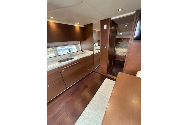  Yacht Photos Pics Luxurious interior of 2014 Sea Ray 470 Sundancer yacht with modern kitchen and cozy cabin.
