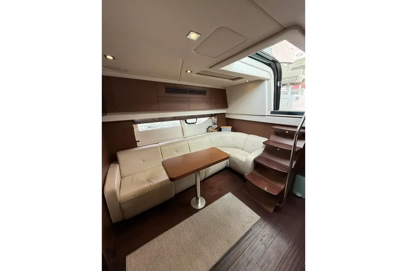  Yacht Photos Pics Luxurious interior of 2014 Sea Ray 470 Sundancer yacht with elegant seating and wooden accents.