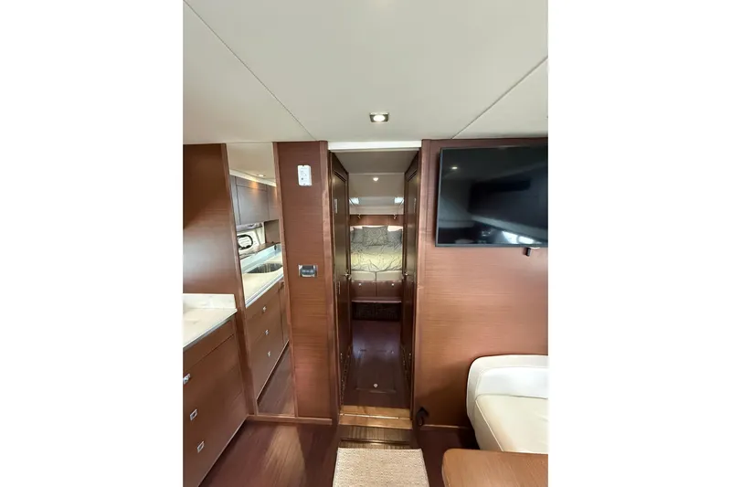  Yacht Photos Pics 2014 Sea Ray 470 Sundancer interior with modern wood finish and mounted TV.