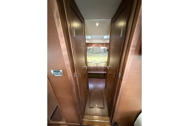  Yacht Photos Pics Interior hallway of 2014 Sea Ray 470 Sundancer yacht with wooden doors and cozy lighting.