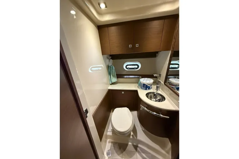  Yacht Photos Pics Luxurious bathroom in 2014 Sea Ray 470 Sundancer yacht with modern fixtures and wood cabinetry.