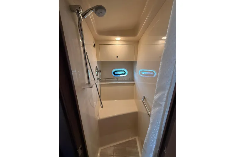  Yacht Photos Pics Shower area in 2014 Sea Ray 470 Sundancer yacht with modern fixtures and porthole window.