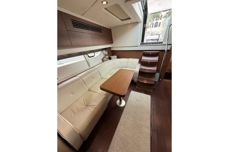  Yacht Photos Pics Luxurious interior of 2014 Sea Ray 470 Sundancer yacht with elegant seating and wooden accents.