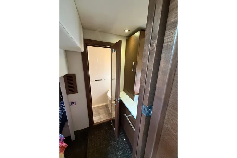  Yacht Photos Pics Interior view of 2014 Sea Ray 470 Sundancer yacht bathroom with wooden cabinetry.