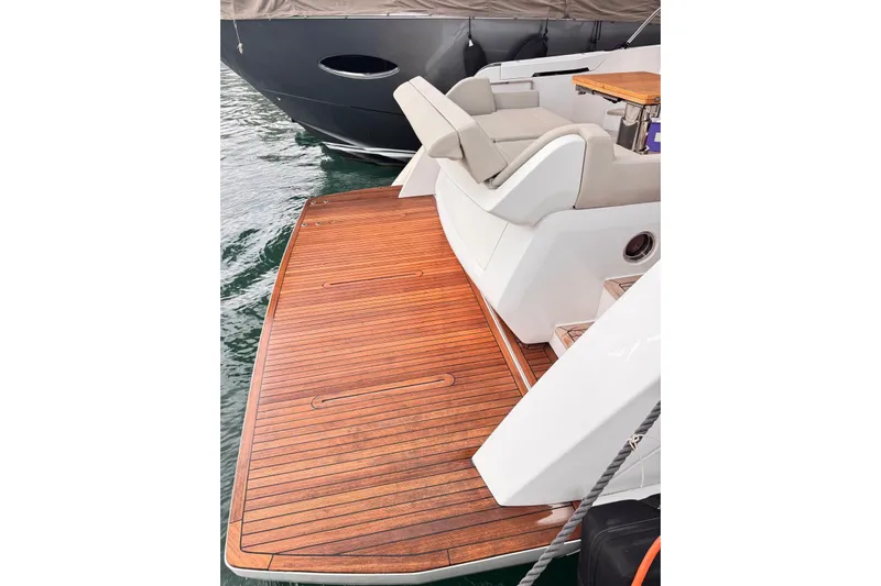  Yacht Photos Pics 2025 Ferretti Yachts 500, elegant teak deck and seating area, docked on water.