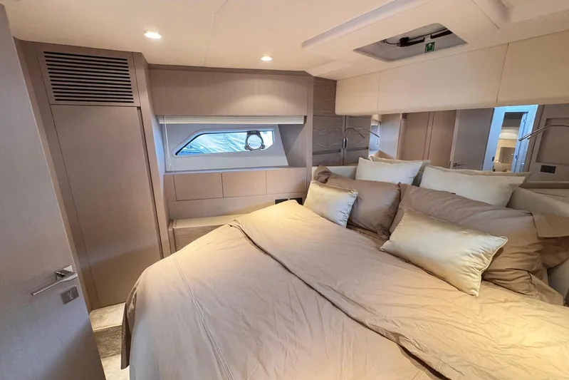  Yacht Photos Pics Luxurious bedroom interior of 2025 Ferretti Yachts 500, featuring elegant bedding and modern design.
