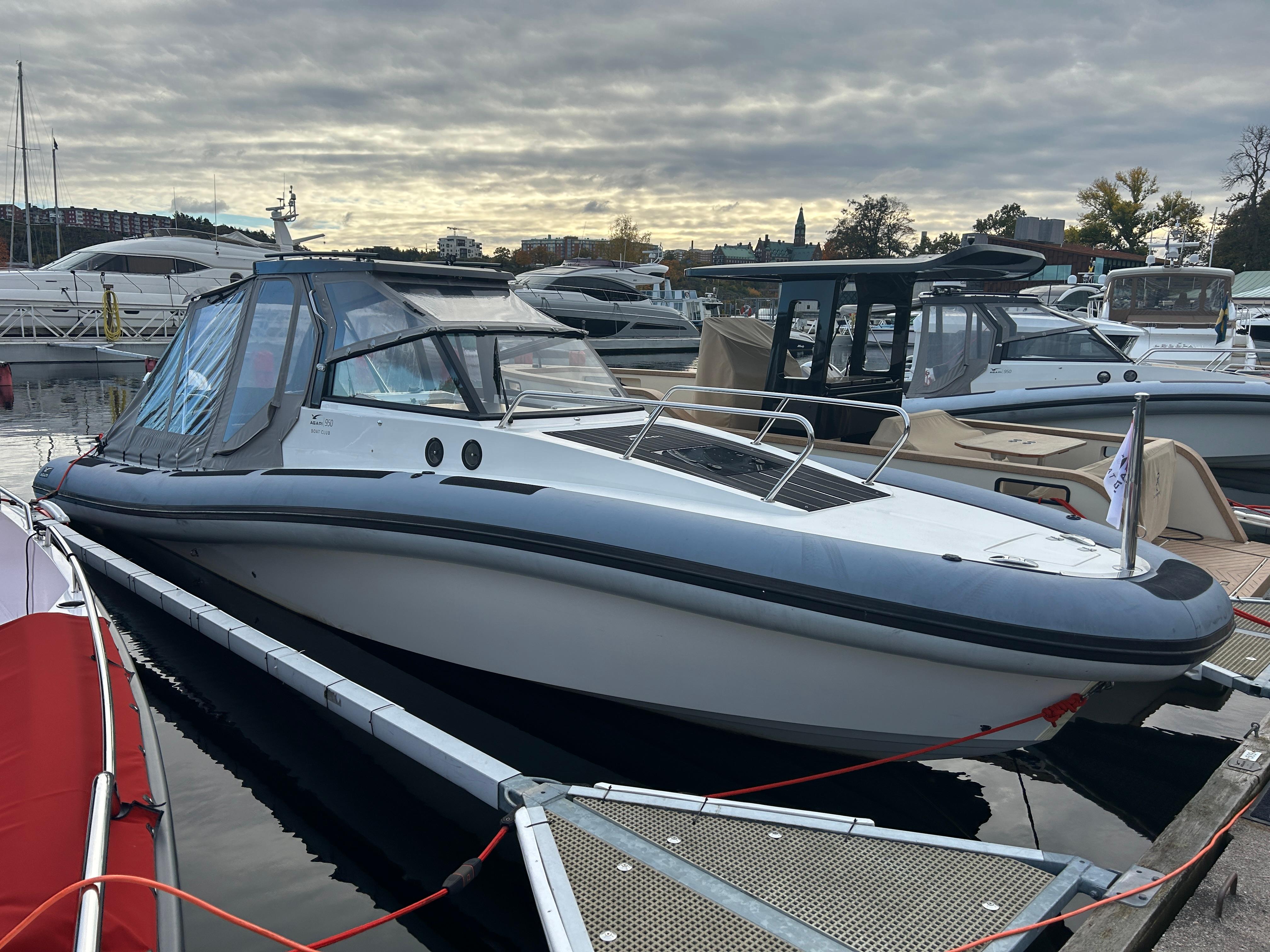 2018 Agapi 950 boat docked at marina under cloudy sky.