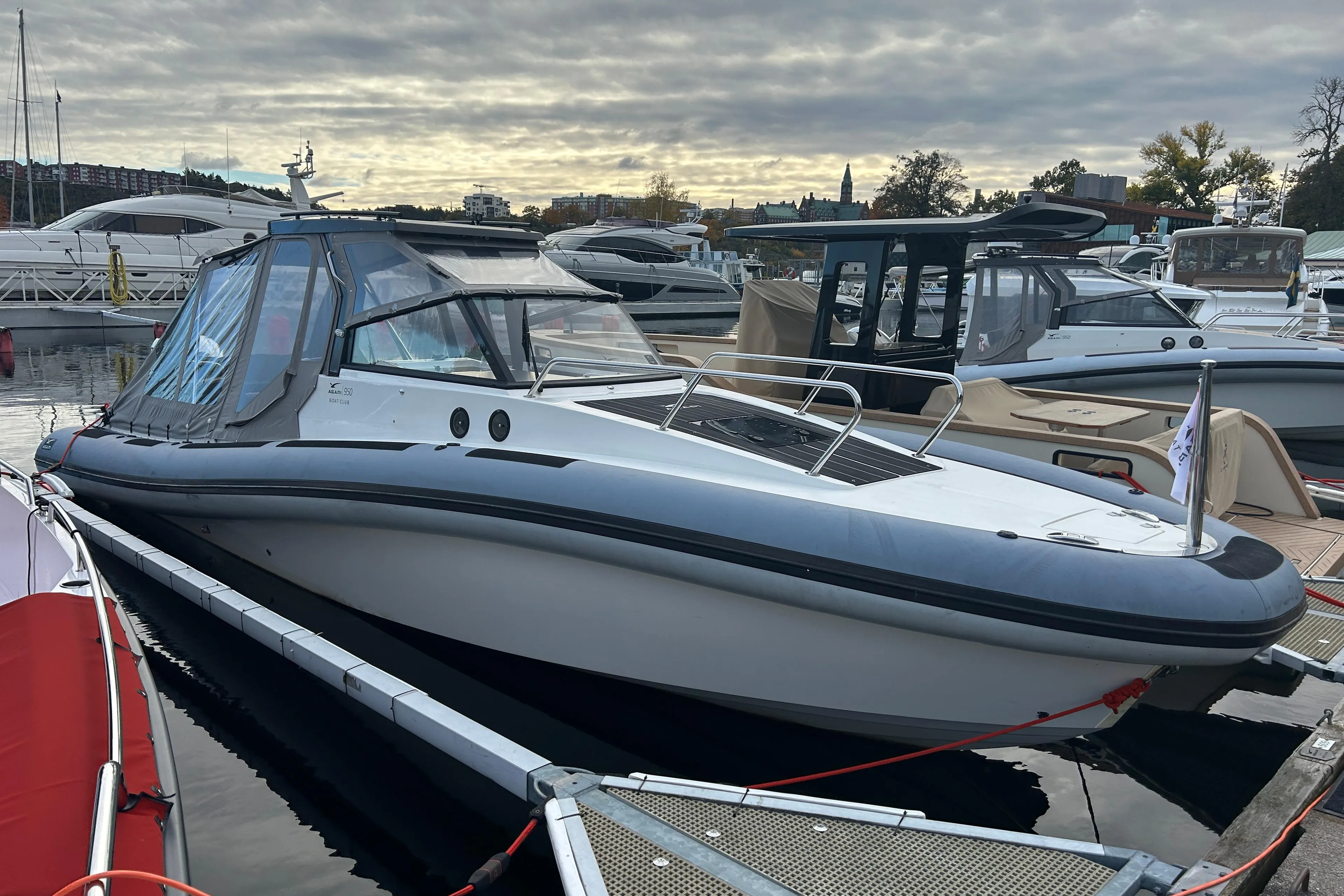 2018 Agapi 950 boat docked at marina under cloudy sky.