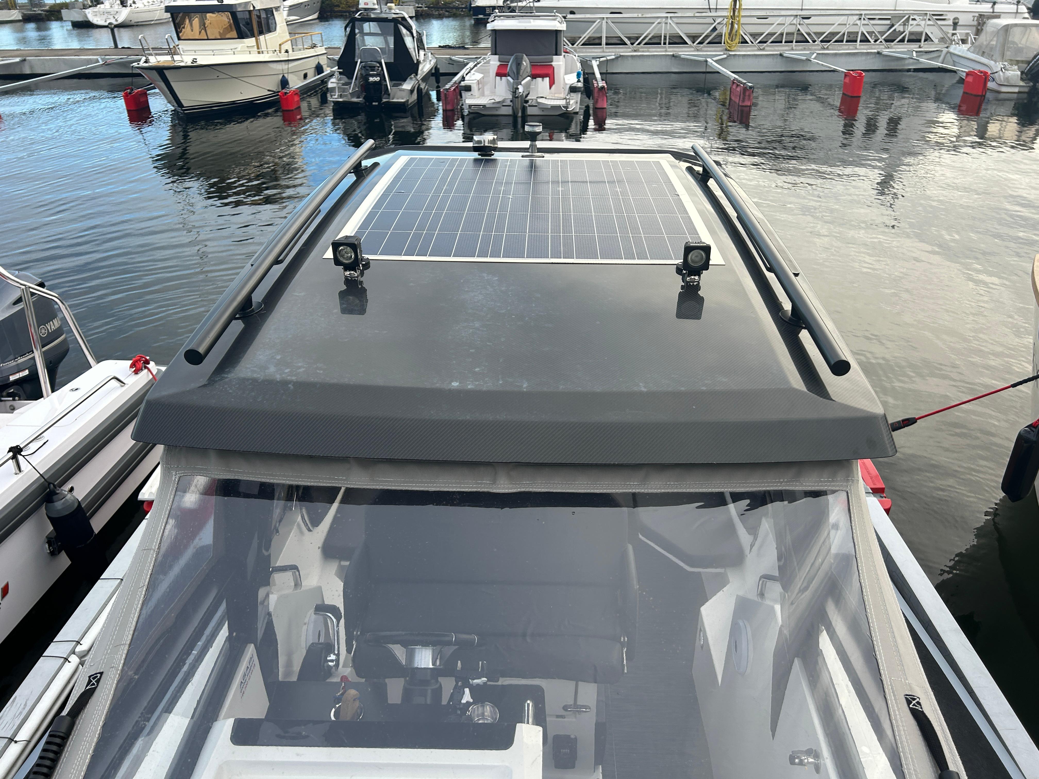 Agapi 950 boat with solar panels docked at marina, 2018 model.