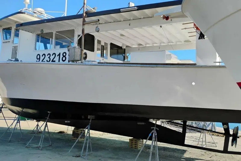 Annabel C Yacht Photos Pics 1987 Monroe Custom 52 boat on stands, hull number 923218, in a shipyard.