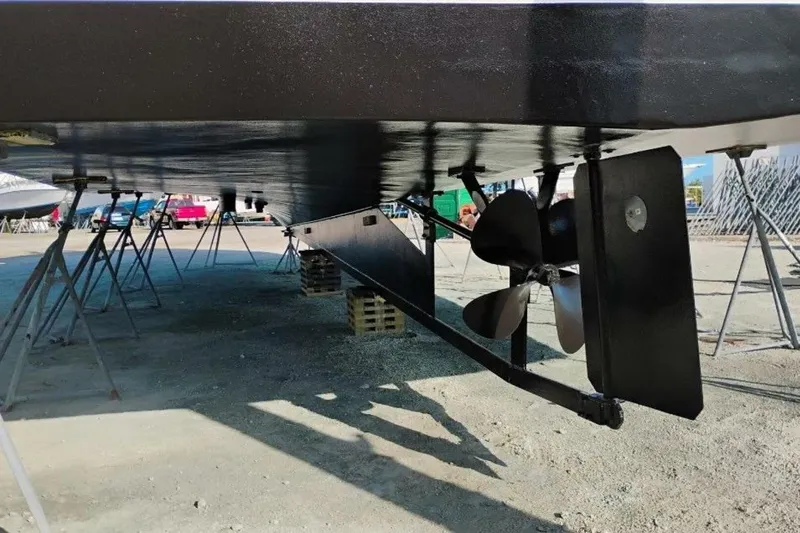 Annabel C Yacht Photos Pics Underneath view of a 1987 Monroe Custom 52 boat on stands, showing propeller and rudder.