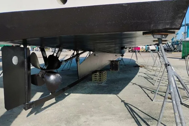 Annabel C Yacht Photos Pics Underneath view of a 1987 Monroe Custom 52 boat on stands, showing propeller and rudder.