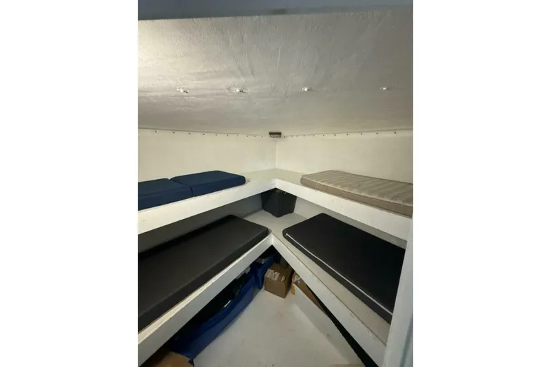 Annabel C Yacht Photos Pics Interior cabin of 1987 Monroe Custom 52 with multiple cushioned bunks.