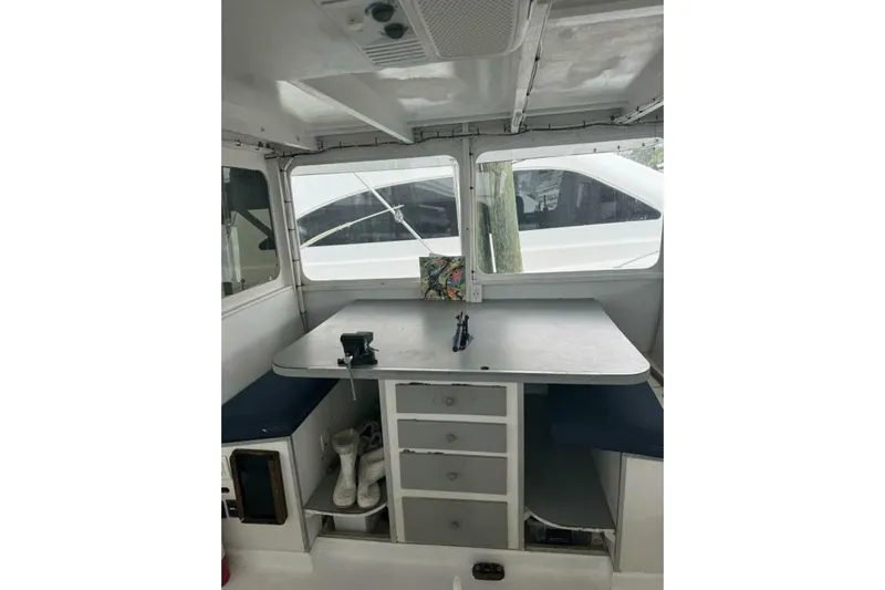 Annabel C Yacht Photos Pics Interior of 1987 Monroe Custom 52 boat with table, seating, and storage.