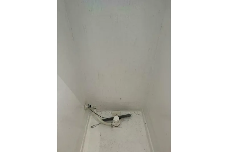 Annabel C Yacht Photos Pics Empty white compartment with a small pipe and valve, Monroe Custom 52, 1987 model.