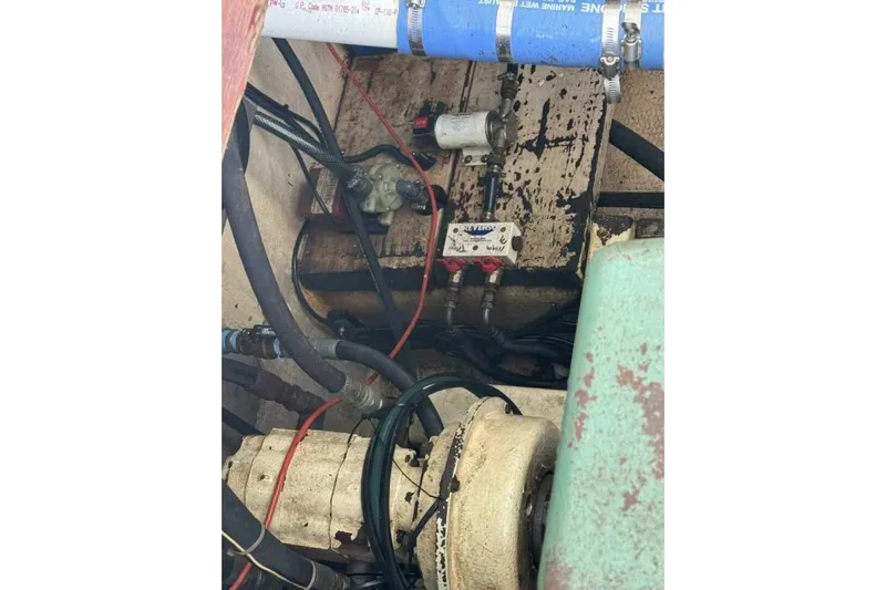 Annabel C Yacht Photos Pics Engine compartment of a 1987 Monroe Custom 52, showing hoses and mechanical components.