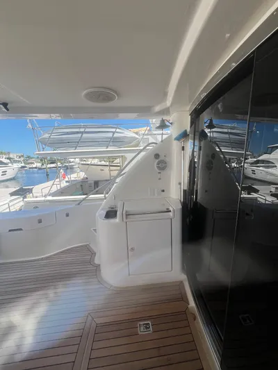  Yacht Photos Pics 2005 Neptunus 62 Flybridge yacht deck with sleek design and marina view.