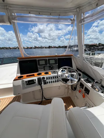  Yacht Photos Pics 2005 Neptunus 62 Flybridge yacht helm with panoramic water view.