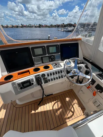  Yacht Photos Pics Helm of 2005 Neptunus 62 Flybridge yacht with navigation equipment and steering wheel.