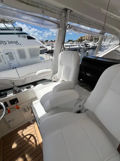  Yacht Photos Pics Luxurious 2005 Neptunus 62 Flybridge yacht interior with white seating and marina view.