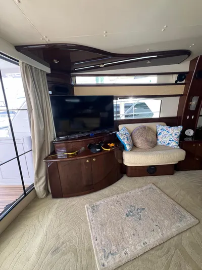  Yacht Photos Pics Luxurious interior of 2005 Neptunus 62 Flybridge yacht with TV and seating area.