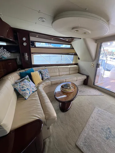  Yacht Photos Pics Luxurious interior of 2005 Neptunus 62 Flybridge yacht with elegant seating and decor.