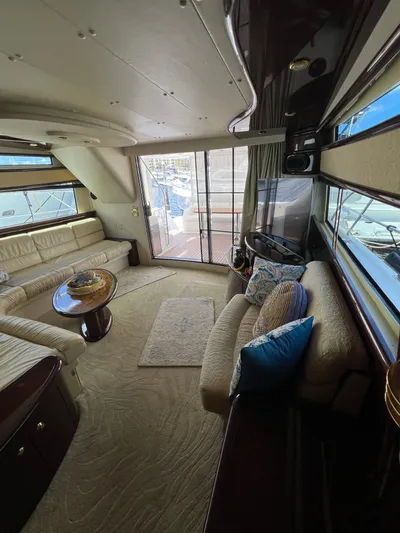  Yacht Photos Pics Luxurious 2005 Neptunus 62 Flybridge yacht interior with elegant seating and panoramic windows.