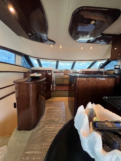  Yacht Photos Pics Luxurious interior of 2005 Neptunus 62 Flybridge yacht with elegant wood finishes.