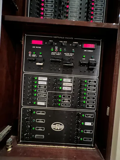  Yacht Photos Pics Control panel of a 2005 Neptunus 62 Flybridge yacht with labeled switches and indicators.
