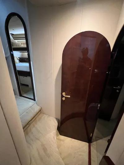  Yacht Photos Pics Interior of 2005 Neptunus 62 Flybridge yacht with elegant wood door and plush carpeting.