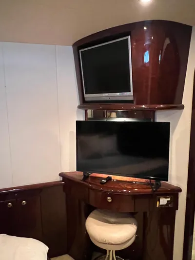  Yacht Photos Pics Luxurious 2005 Neptunus 62 Flybridge yacht interior with dual TVs and elegant wood finish.