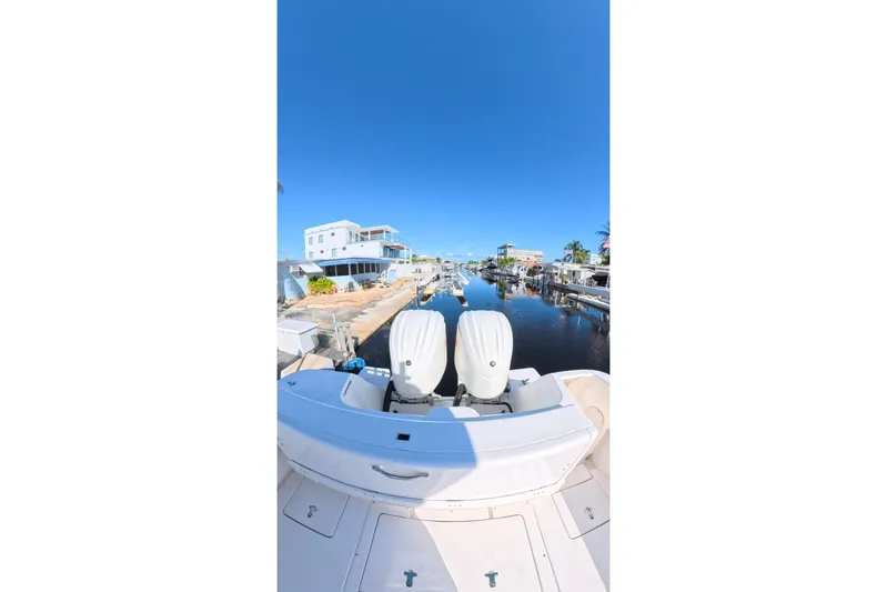  Yacht Photos Pics 2014 Intrepid 327 Center Console boat docked in a sunny marina.