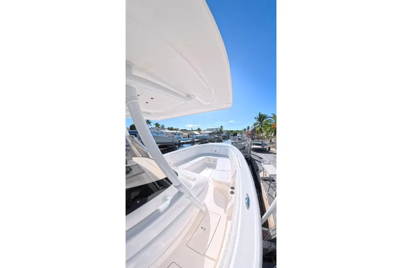  Yacht Photos Pics 2014 Intrepid 327 Center Console boat docked under clear blue sky.